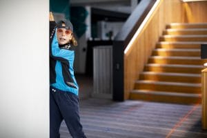 A young person performs wearing a cap and sunglasses