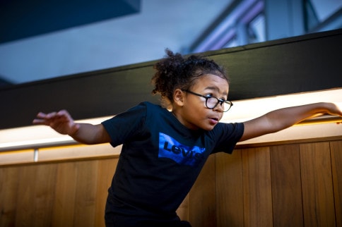 A young child performing on a staircase at The Marlowe.