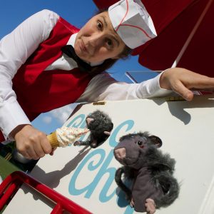 Photo of woman feeding an ice cream to puppet rats